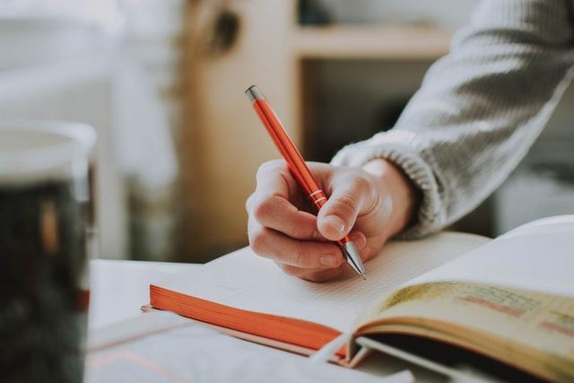 person writing in a notebook