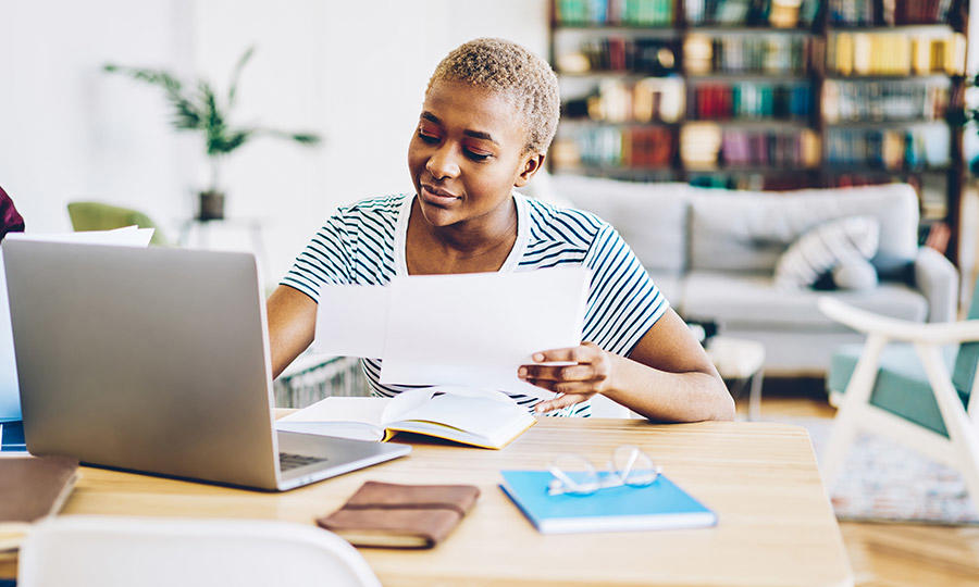 Student at home studying laptop